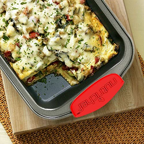 Baked dish with melted cheese and herbs in a pan.