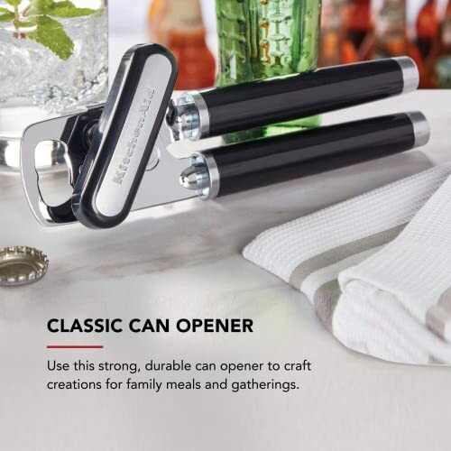 Classic can opener on a kitchen counter with a bottle cap nearby.
