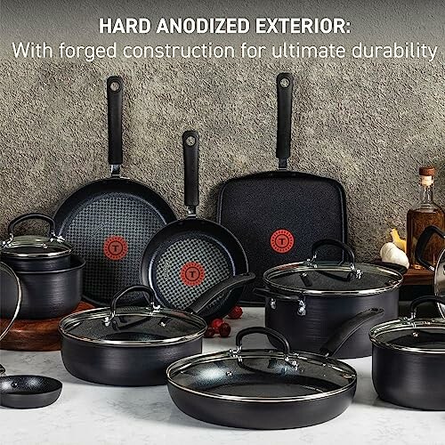 Hard anodized cookware set with frying pans and pots on counter.
