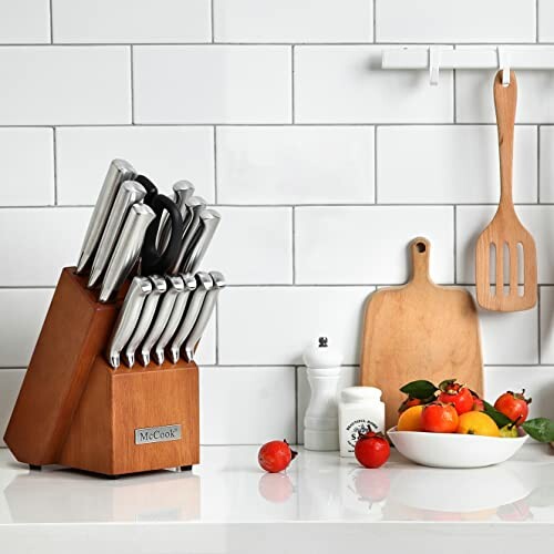 Knife set on kitchen counter with cutting board and vegetables.