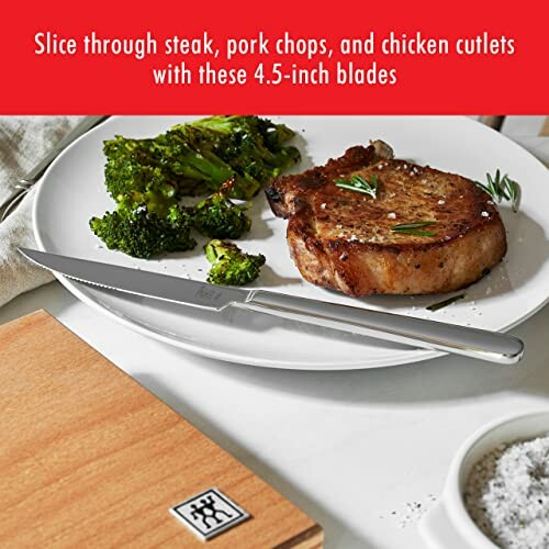 Knife and steak with broccoli on a plate.