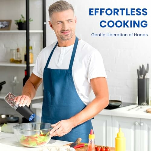 Man in apron preparing salad in kitchen