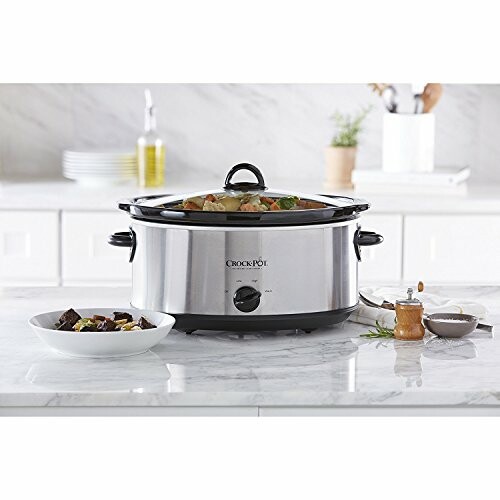 Slow cooker on kitchen counter with food and utensils.