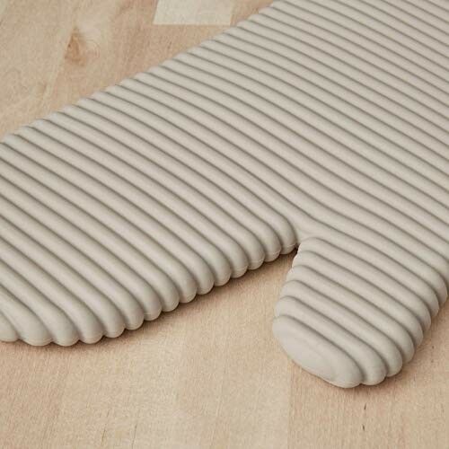 Textured oven mitt on wooden surface.