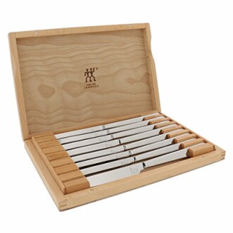 Wooden box with a set of steak knives inside.